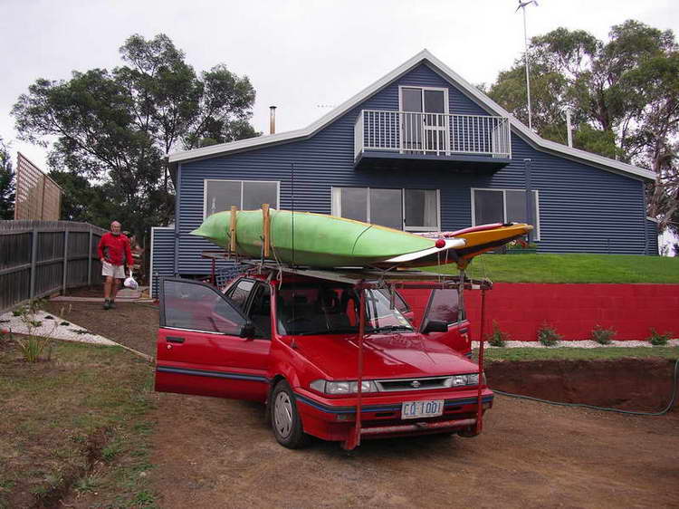 The little Pulsar loaded with the three sea kayaks.